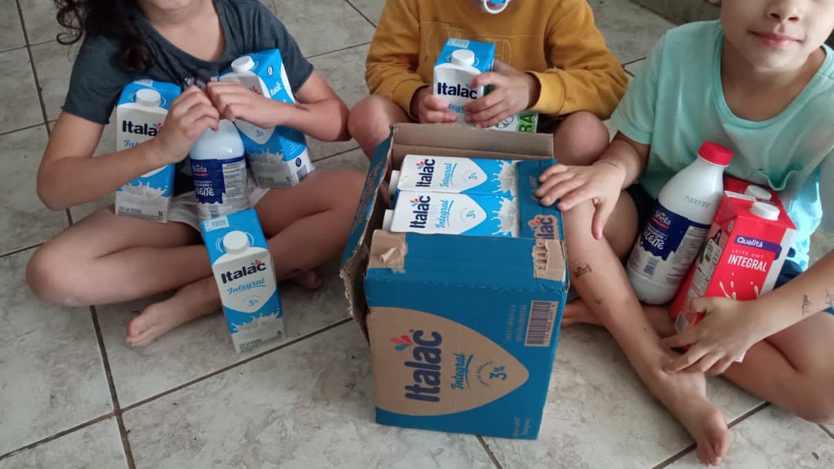 Crianças e famílias reunidas em atividade de acolhimento com doações — registro 011