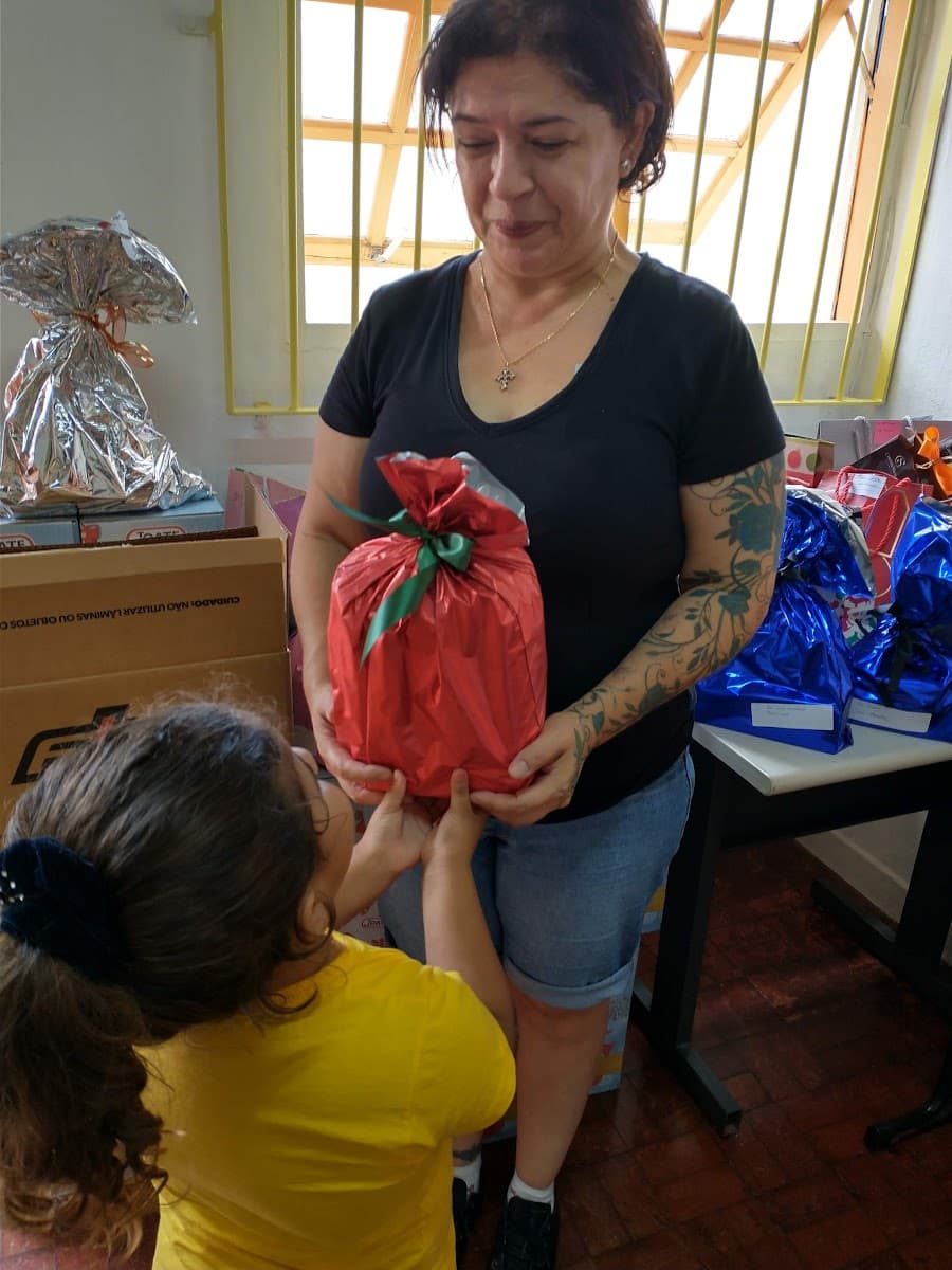 Grupo reunido diante de decoração natalina durante encontro da ACAI — registro 054