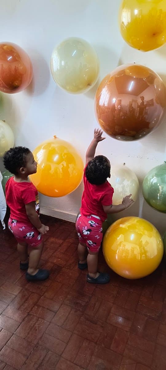 Crianças brincando com balões durante encontro da ACAI